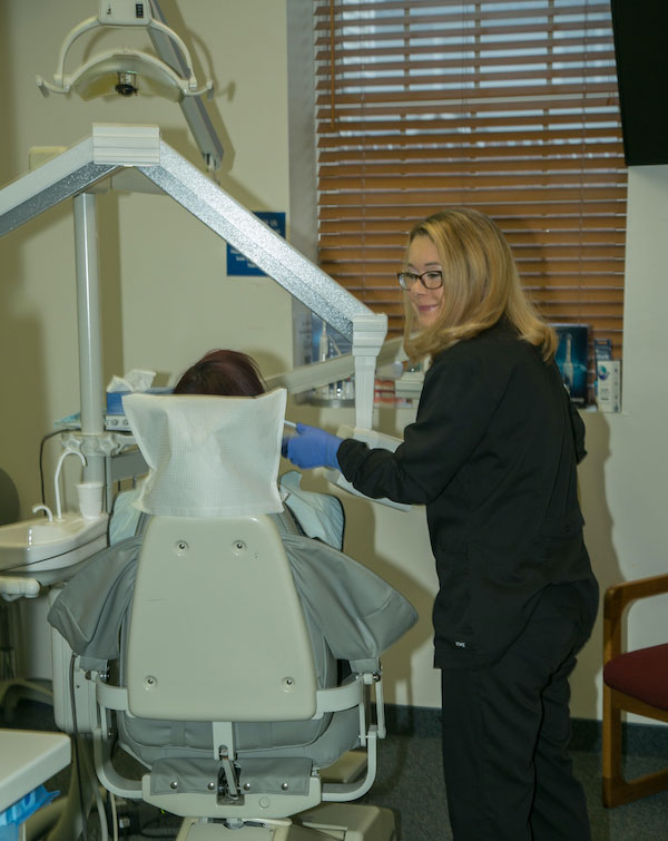 dental hygienist working on a patient at Castle Family Dentistry in Washington, New Jersey