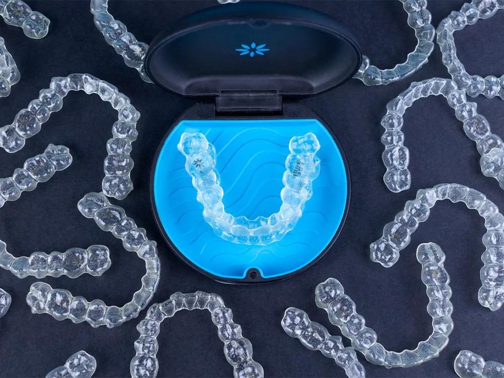 Invisalign clear aligners on a dark blue background